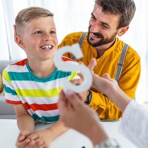 speech-therapist-works-with-a-young-boy-picture-id1239585319